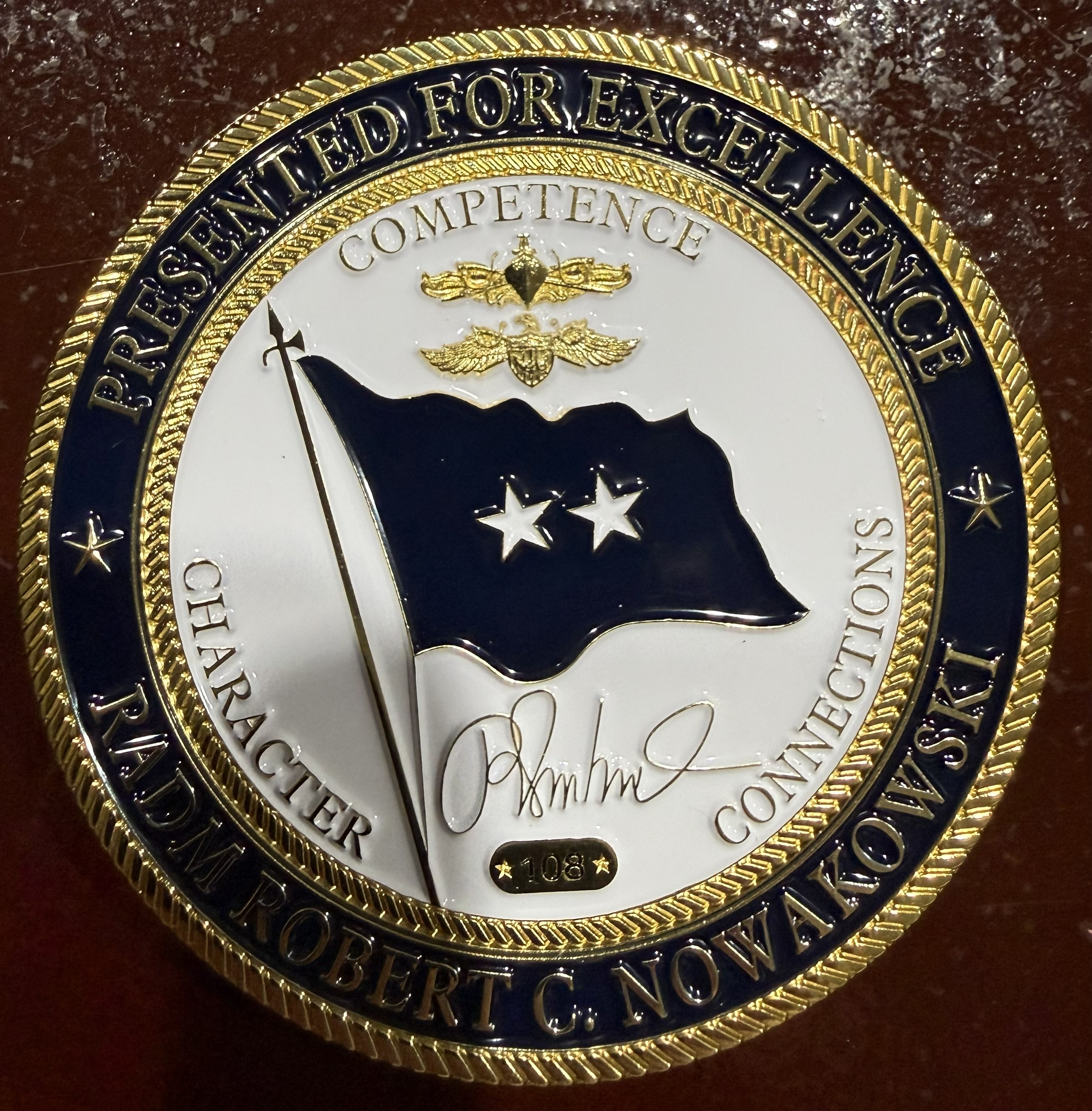 Front of the challenge coin from Rear Admiral Robert Nowakowski's retirement event.