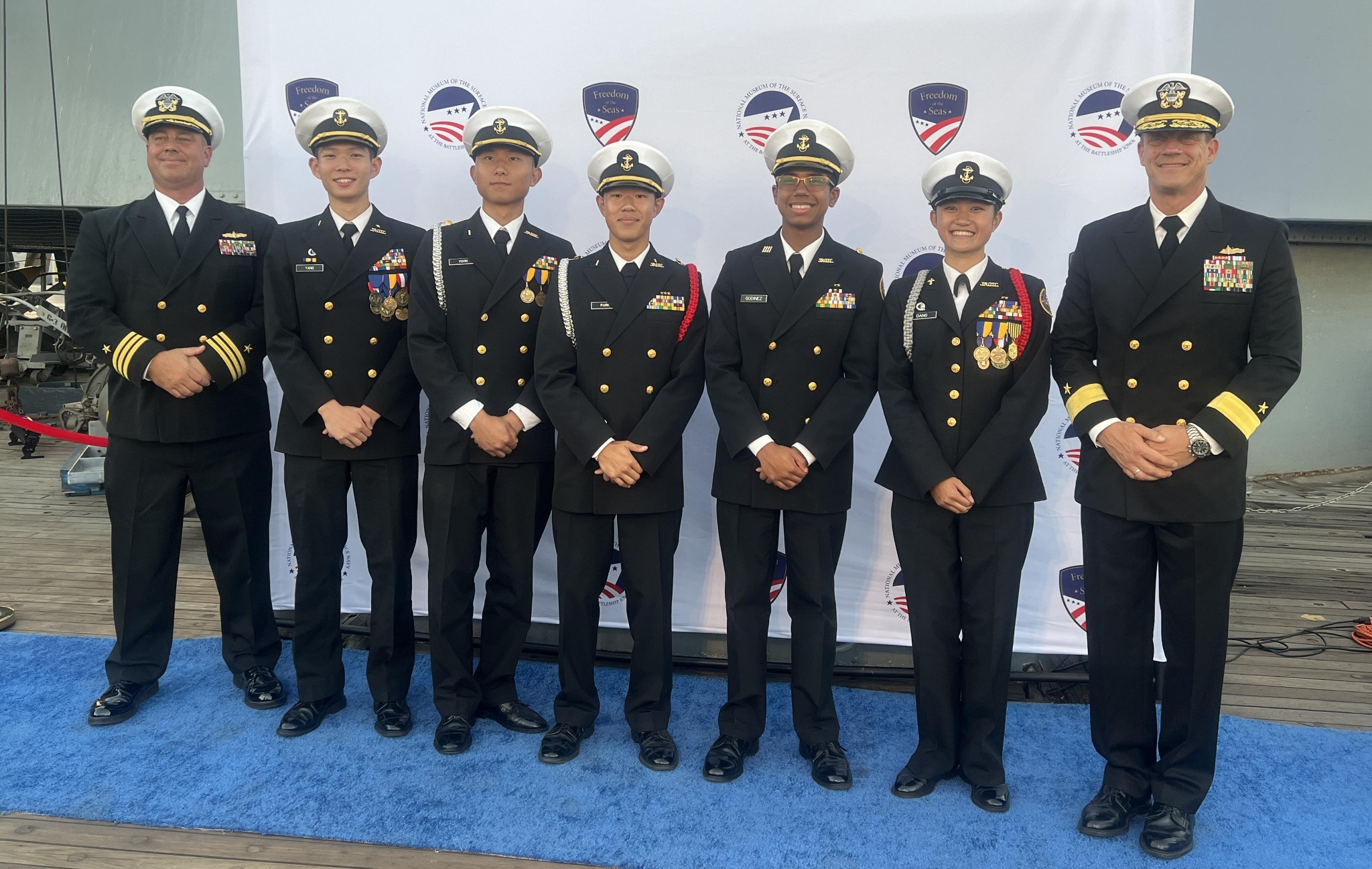 Madison Dang with Rear Admiral Robert Nowakowski and others aboard USS Iowa at the Freedom of the Seas event.